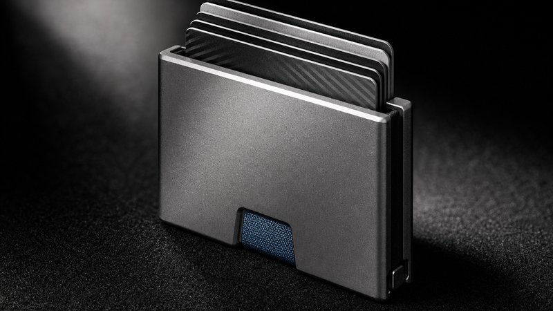 Macro detail of an aluminum minimalist wallet for men on black felt