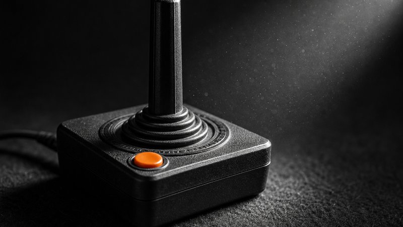 Macro detail of the single-button joystick behind the best Atari 2600 games