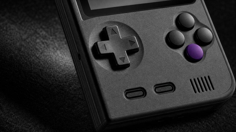 Macro of a retro handheld D-pad, the button feel side of the Miyoo Mini Plus vs TrimUI Brick comparison