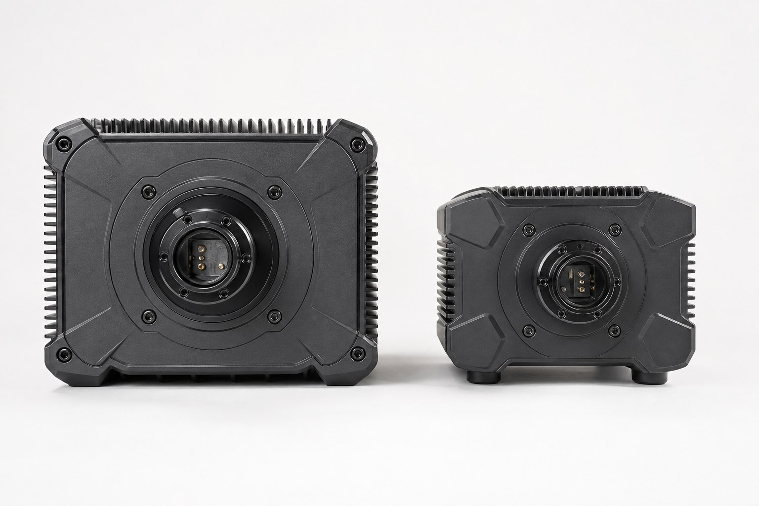 Two direct-drive sim racing wheel bases placed side by side for comparison